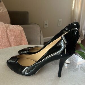 Open toe black heels.